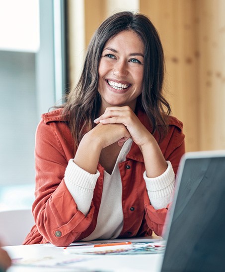 Woman smiling during meeting in office