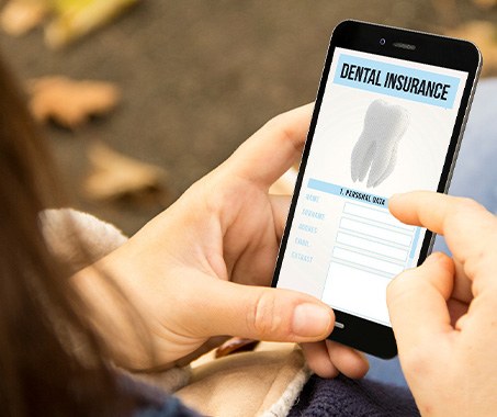A woman looking at a dental insurance app