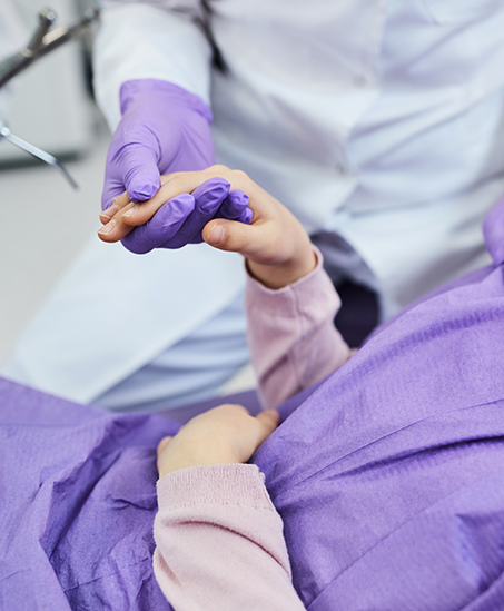 Dentist holding a patient's hand