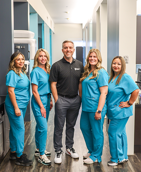 Doctor Goodman and four smiling dental team members