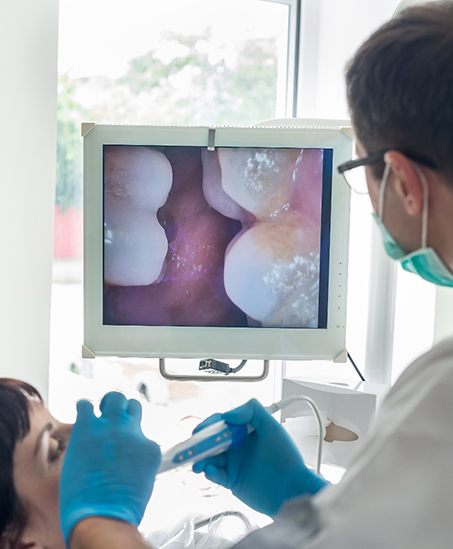 Dentist taking close up photos of a patient's teeth