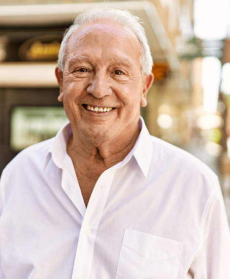 Smiling senior man in a white button down shirt