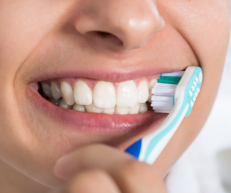 Close up of a person brushing their teeth