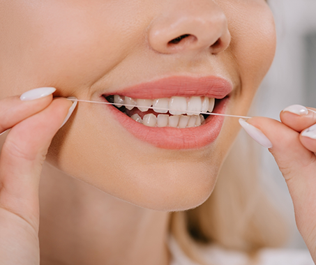 Person flossing their teeth