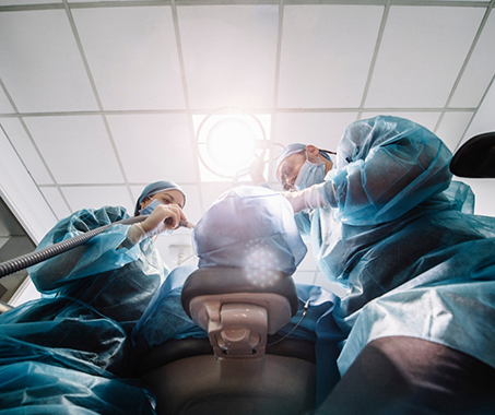 Dentist and assistant treating a patient
