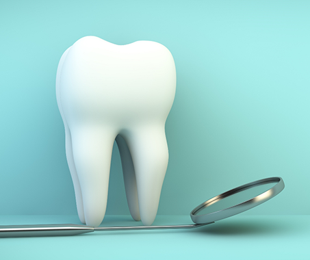 Model of a tooth next to a dental mirror
