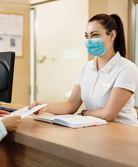 Dental team member helping a patient check in