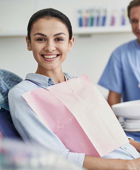 Smiling young woman in the dental chair