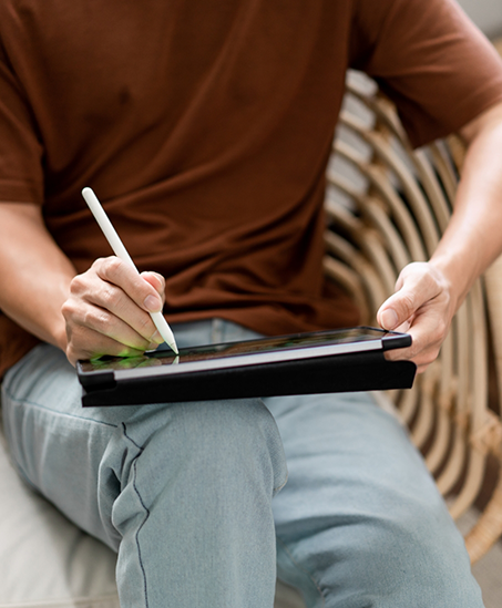 Person filling out forms on a tablet