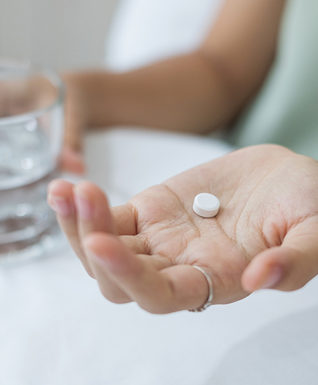 Person taking a pill for sedation dentistry in Goodyear
