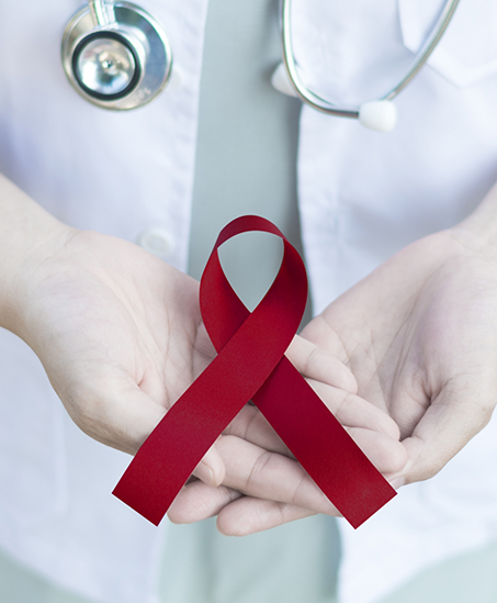 Dentist holding a red ribbon