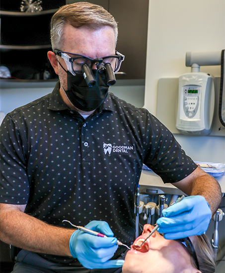 Doctor Goodman wearing personal protective equipment while treating a patient