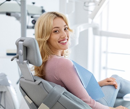 Patient smiling while sitting in treatment chair
