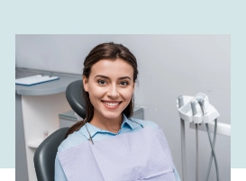 Smiling brunette woman in the dental chair