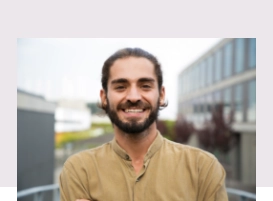 Young man in a yellow shirt smiling